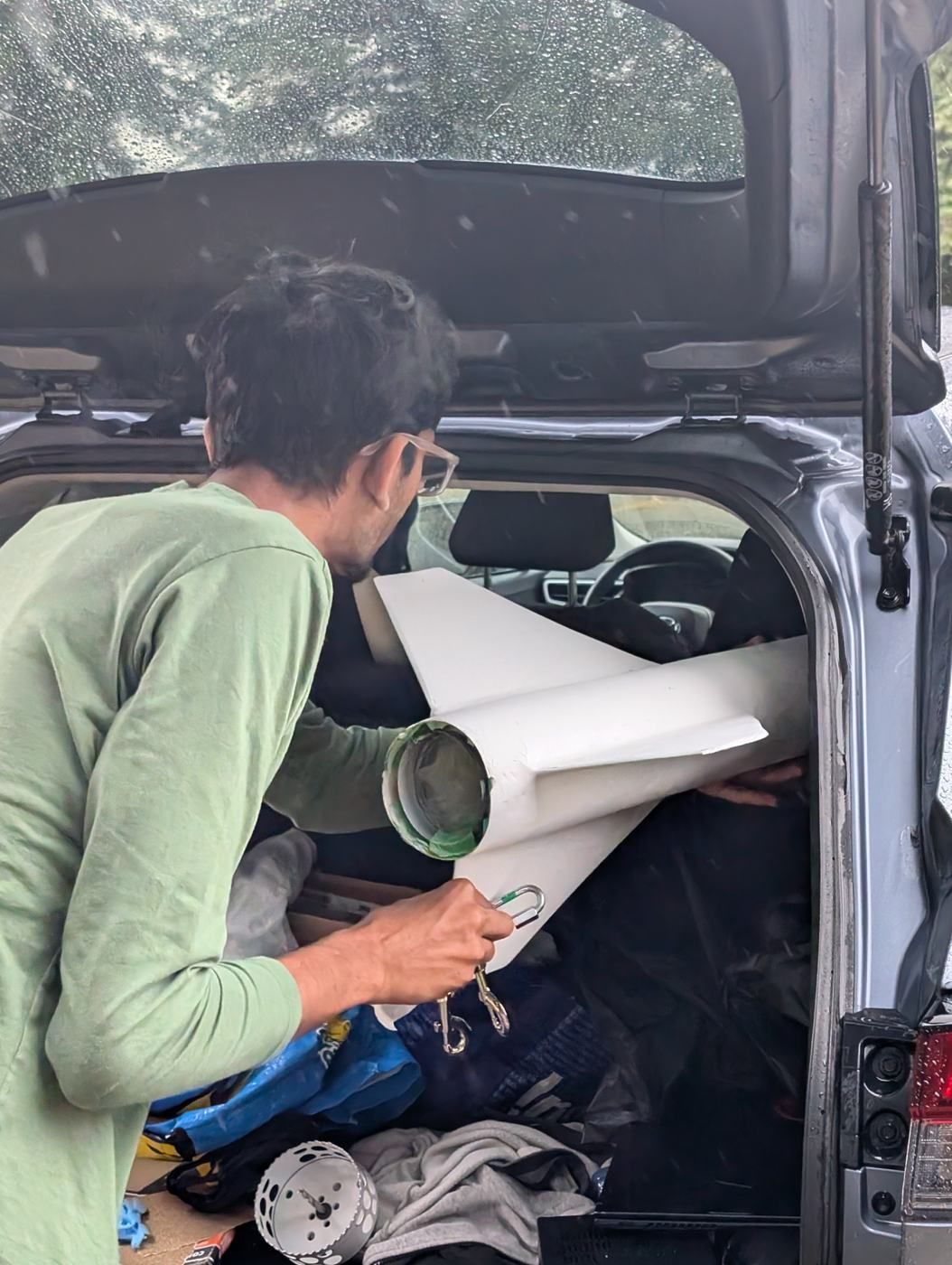 A member loading airframe parts into the back of a car